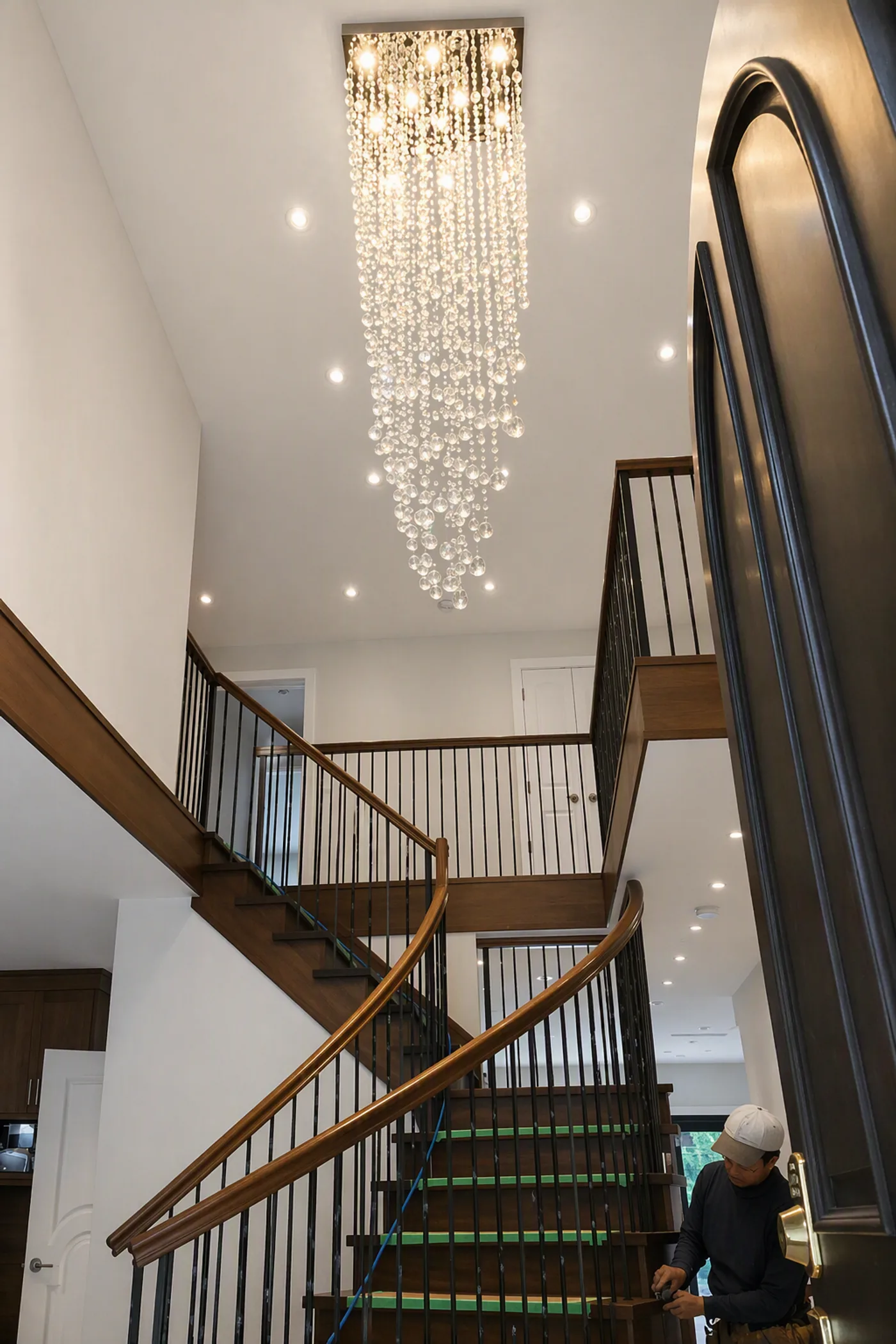 4032 Marine Dr grand curved staircase with crystal chandelier